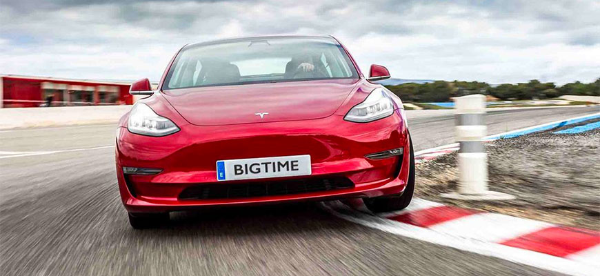 A photo of a red Tesla on a race track